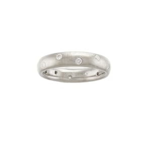 May include: A silver band ring with a brushed finish and small round diamonds set around the band.