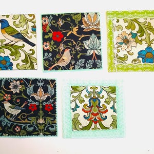 May include: Five square fabric patches featuring intricate botanical and avian patterns. The designs include blue birds, speckled birds, red flowers, and green foliage on cream and dark navy backgrounds, with some edges finished in light green lace.
