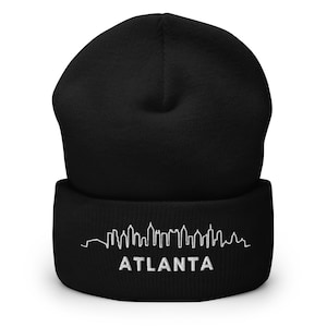 May include: Black beanie with a white embroidered skyline of Atlanta.