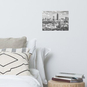 May include: Black and white aerial photograph of the Atlanta skyline with the text "ATLANTA" superimposed over the image.