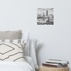 May include: Black and white aerial photograph of the Atlanta skyline with the text "ATLANTA" superimposed on the image.