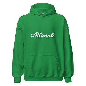 May include: Green hooded sweatshirt with the word "Atlanuh" in white cursive lettering on the front.