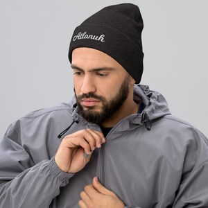 May include: A black beanie with the word "Atlanuh" embroidered in white on the front.