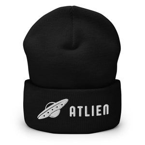 May include: Black beanie with a white embroidered alien spaceship and the word "ATLIEN" on the cuff.