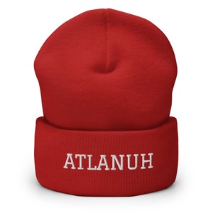 May include: Red knit beanie with a white embroidered logo that says "ATLANUH"