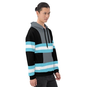 May include: A black, gray, and light blue striped hoodie with a drawstring hood.