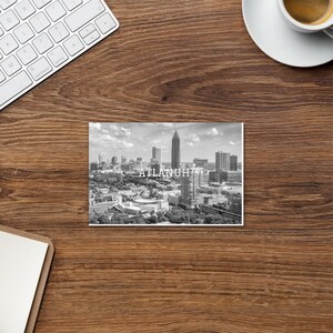May include: A black and white photograph of the Atlanta skyline with the text "ATLANTA, GA" printed on the bottom.