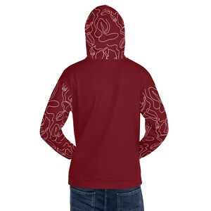 May include: A maroon hoodie with white abstract floral pattern on the sleeves and hood.