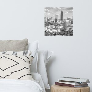 May include: Black and white aerial photograph of the Atlanta skyline with the text "ATLANTA" superimposed over the image.