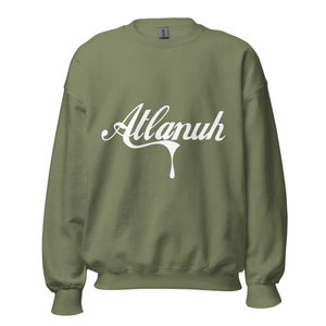 May include: A green sweatshirt with a white graphic that says "Atlanuh" in a dripping font.