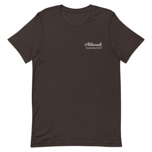 May include: A dark brown t-shirt with the text "Atlanuh Established 1847" in white lettering.
