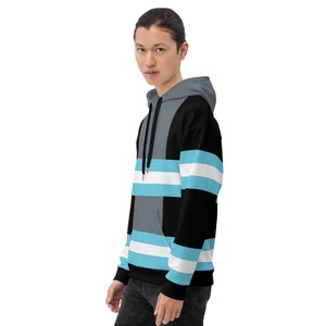 May include: A black, gray, and light blue striped hoodie with a drawstring hood.