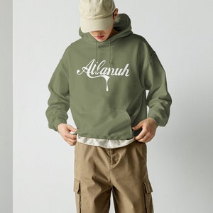 May include: A green hooded sweatshirt with a white graphic that says "Ailanuh" in a dripping font.