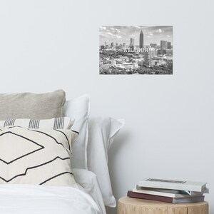 May include: A black and white aerial photograph of the Atlanta skyline with the text "ATLANTA" superimposed over the image.