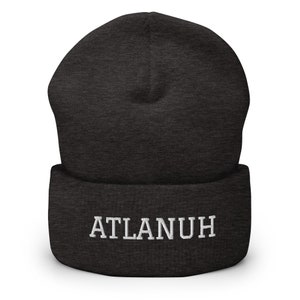 May include: A dark gray beanie with a white embroidered word "ATLANUH" on the cuff.