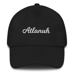 May include: A black baseball cap with a white embroidered cursive word "Atlanuh" on the front.