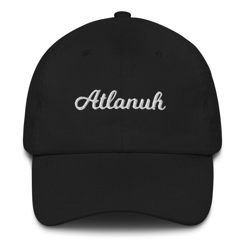 May include: A black baseball cap with a white embroidered cursive word "Atlanuh" on the front.