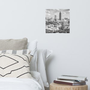 May include: Black and white aerial photograph of the Atlanta skyline with the text "ATLANTA" superimposed over the image.
