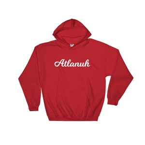 May include: Red hooded sweatshirt with the word "Atlanuh" in white cursive lettering.