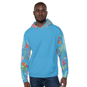 May include: A light blue hoodie with a floral pattern on the sleeves. The hoodie has a kangaroo pocket and a drawstring hood.