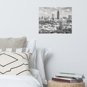 May include: Black and white aerial photograph of the Atlanta skyline with the text "ATLANTA" superimposed over the image.