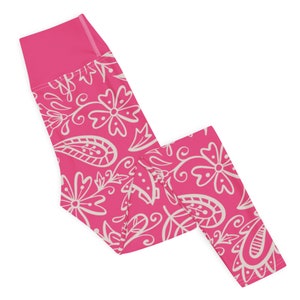 May include: Pink leggings with a white paisley and floral pattern.