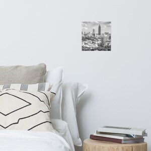 May include: Black and white photograph of the Atlanta skyline with the text "ATLANTA" superimposed over the image.