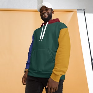 May include: A green, blue, and yellow color block hoodie with a white drawstring. The hoodie has a kangaroo pocket.