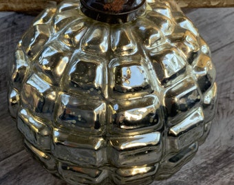 May include: Silver-colored, textured glass Christmas ornament with a geometric pattern. The ornament has a dark brown metal cap and a natural rope loop for hanging. The reflective surface creates a vintage aesthetic.