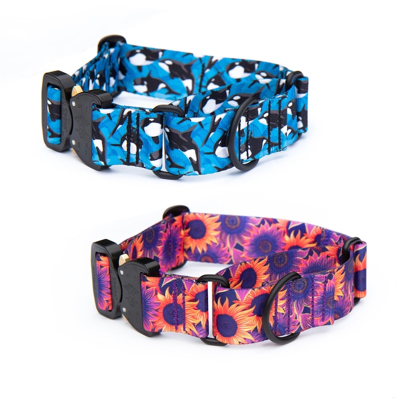 May include: Two adjustable pet collars with black metal buckles and D-rings. The top collar features a blue and black orca whale pattern. The bottom collar displays a vibrant sunflower print with orange, yellow, and purple petals on a dark background.