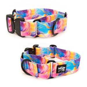 May include: A dog collar featuring a vibrant, swirling marble pattern in shades of blue, pink, and yellow. It includes a black metal buckle, black hardware rings, and a black rectangular patch with the white text SeaFlower Co.