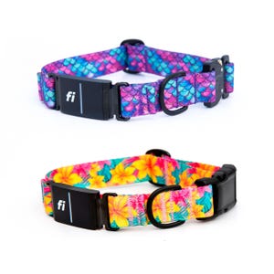 May include: Two smart dog collars with black hardware and a rectangular module featuring the text fi. The top collar has a purple and blue mermaid scale pattern. The bottom collar features a vibrant tropical floral print with yellow flowers.