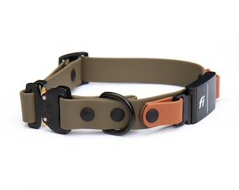 May include: An olive green dog collar featuring a black metal buckle, a black D-ring, and a black electronic tracking module with the white text fi printed on the front. The collar includes tan leather-like accents secured by black rivets.