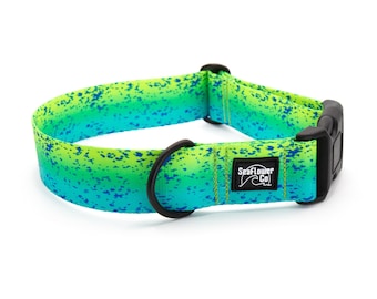 May include: A dog collar with a vibrant gradient of green and blue, speckled with darker blue spots. The collar features a black buckle and a black metal ring for leash attachment. The brand name "SeaFlower Co" is visible on a small label.
