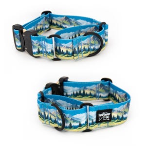 May include: A blue dog collar featuring a printed landscape of mountains, pine trees, and green fields. The collar includes a black plastic buckle, black metal D-rings, and a black fabric tag with the white text SeaFlower Co.
