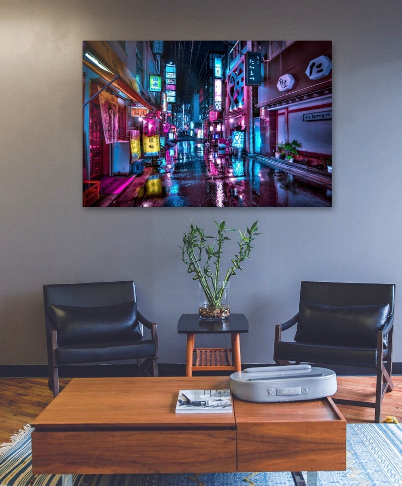 May include: A neon-lit street scene in Japan with colorful signs and wet pavement. The street is lined with buildings and shops, and the atmosphere is vibrant and energetic.