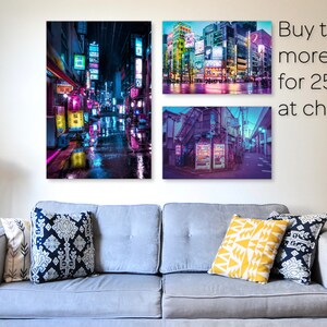 May include: Three colourful photographs of a city street at night with neon lights and signs. The text on the image reads "Buy two or more prints for 25% off at checkout."