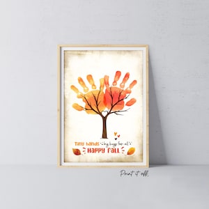 May include: Framed art print featuring a tree design made from handprints in shades of orange and red, with a brown trunk and branches. The text "Tiny hands...big hugs for all...Happy Fall" is included. The print is in a wooden frame.