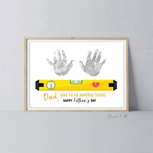 May include: A printable Father's Day card with a yellow level and two gray handprints. The text reads "Dad, you're on another level! Happy Father's Day."