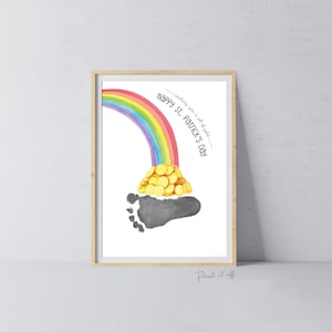 May include: A printable St. Patrick's Day footprint art design featuring a rainbow with a pot of gold at the end. The text reads "Happy St. Patrick's Day - walking you to a pot of gold".