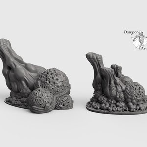 May include: Three miniature grey 3D printed models of fleshy, organic growths with textured surfaces. The models are on a white background.