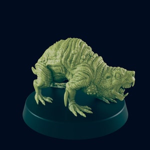 May include: A green, detailed, miniature plastic figure of a grotesque, snarling, rat-like creature with a textured, bumpy surface. The figure is posed on a black circular base.