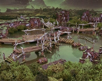 May include: A miniature swamp scene with wooden bridges and walkways over a murky green pond. The scene is surrounded by lush green foliage and moss.