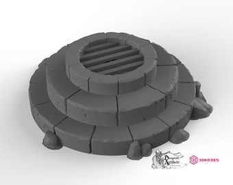 May include: A three-tiered stone well with a metal grate covering the opening. The well is made of gray stone and has a rough, textured surface. The well is surrounded by small rocks.