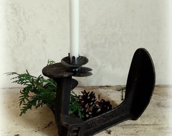 Ancient anvil shoemaker's iron as a winter arrangement/candle holder