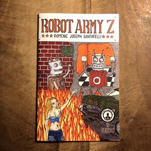 May include: A comic book cover with a red, white, and black robot in the background. The robot is standing in front of a brick wall with a sign that says "Scrap Metal Prices". In the foreground, a woman with long blonde hair is standing in front of a burning car. The comic book is titled "Robot Army Z" and the cover says "Issue 1".