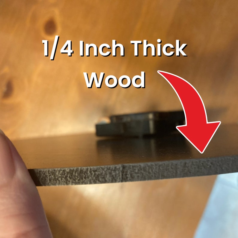 May include: Close-up of a dark brown wood piece, approximately 0.64 cm thick. The edge of the wood is textured, and the surface is smooth and reflective. White text reads "1/4 Inch Thick Wood" with a red arrow.