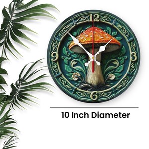 May include: A round wall clock with a mushroom design. The clock face is dark teal with a detailed relief pattern and a central image of a red-capped mushroom. The clock is 10 inches in diameter.