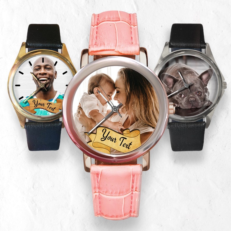 May include: Three wristwatches with customizable photo faces. The watches have black leather bands. The first watch has a gold case and features a photo of a man. The second watch has a silver case and features a photo of a mother and child. The third watch has a silver case and features a photo of a dog. Each watch face has the text "Your Text" on a scroll.