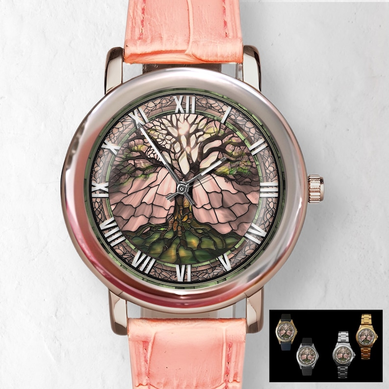 May include: A silver-toned wristwatch with a pink leather band. The watch face features a detailed tree design with Roman numerals. The watch has a round face and a textured, pink leather strap.